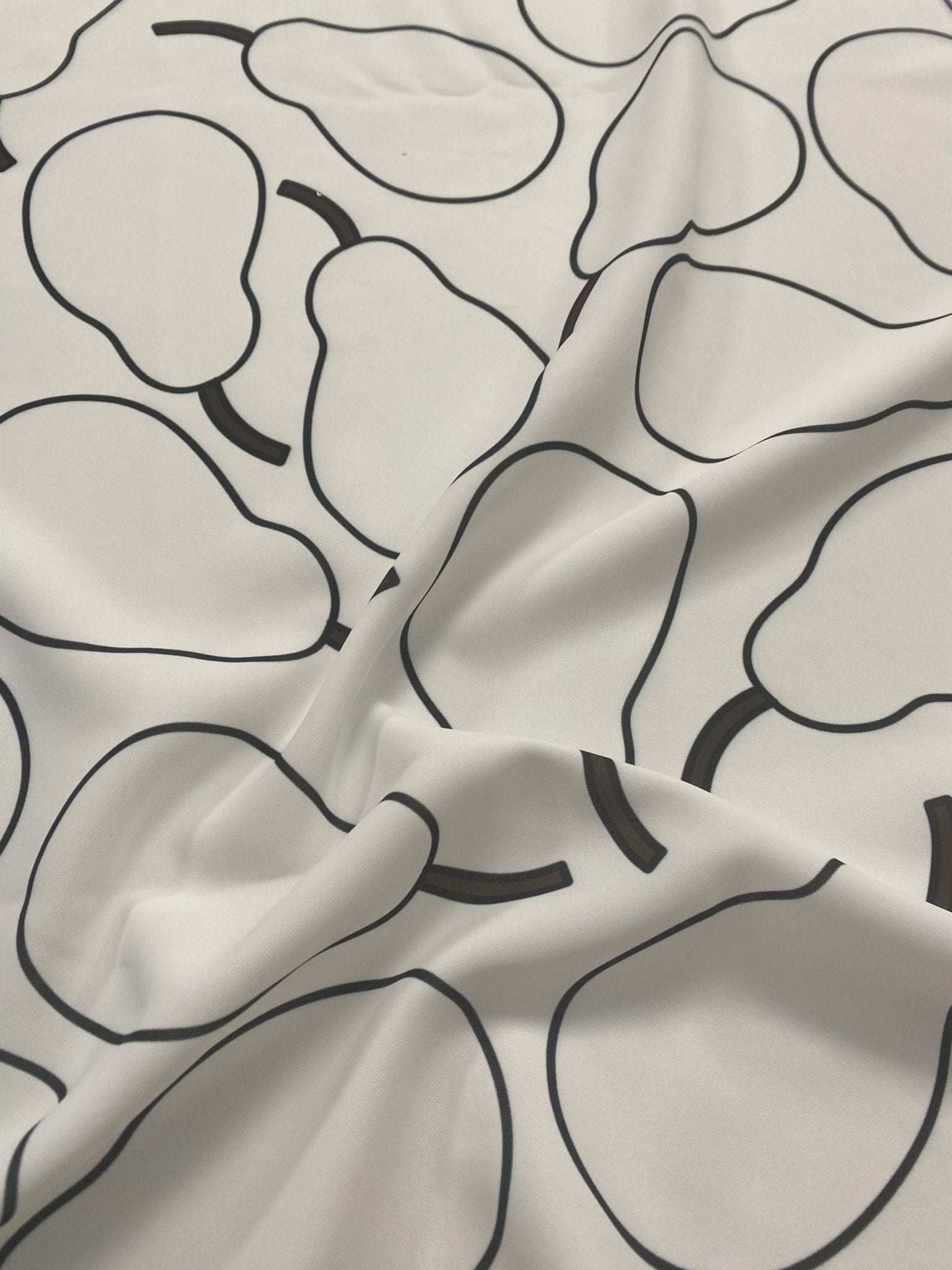 Minimalist pear print fabric with black outlined pears on a light background, soft and durable material for sewing and home decor projects