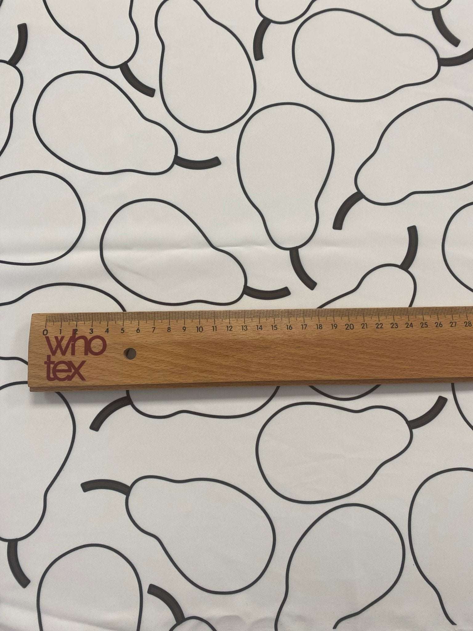 Minimalist pear print fabric with black outlined pears on white background and ruler for scale