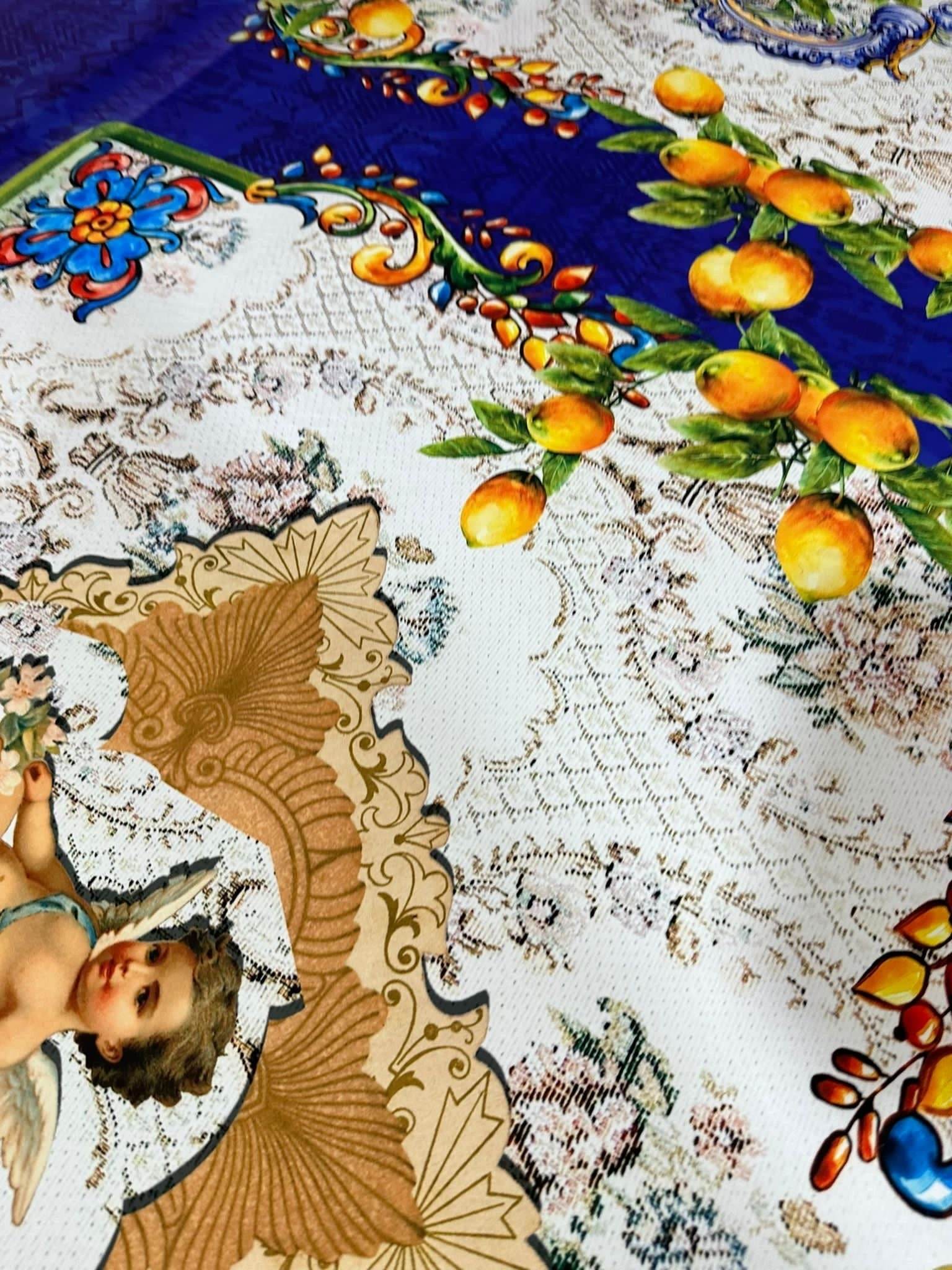 Floral mosaic fabric with lemon motifs and angel design on white and blue background