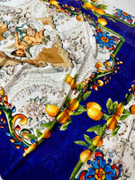 Floral mosaic lemon angel pattern fabric with vibrant blue, yellow lemons, and decorative floral designs