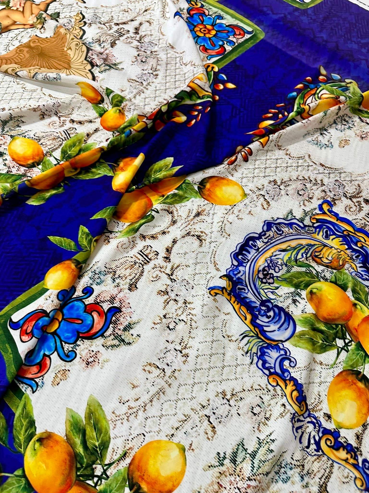 Floral mosaic fabric with lemon and angel pattern in blue, white, and yellow tones, suitable for sewing and crafting projects