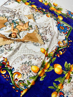 Floral Mosaic Lemon Angel Pattern Fabric with cherub design, lemons, and vibrant mosaic border in blue and orange tones