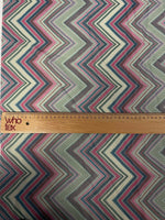 Close-up of multicolor chevron zigzag fabric with ruler showing pattern scale
