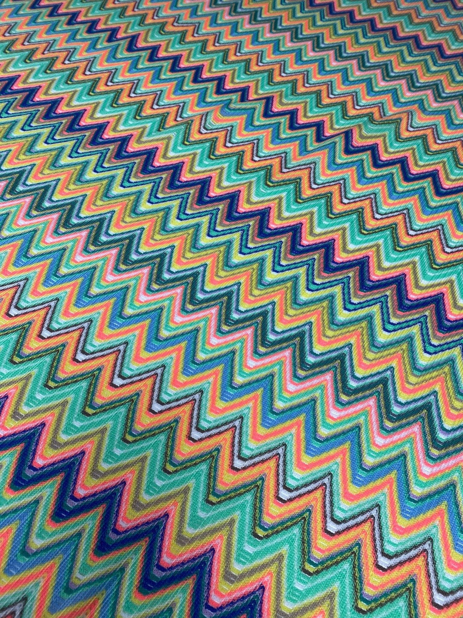 Multicolor chevron zigzag pattern mesh fabric in vibrant green tones for sewing projects