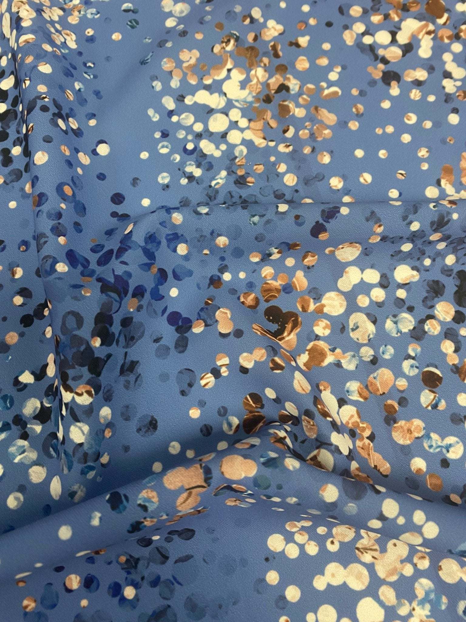 Blue fabric with multicolor confetti dot pattern