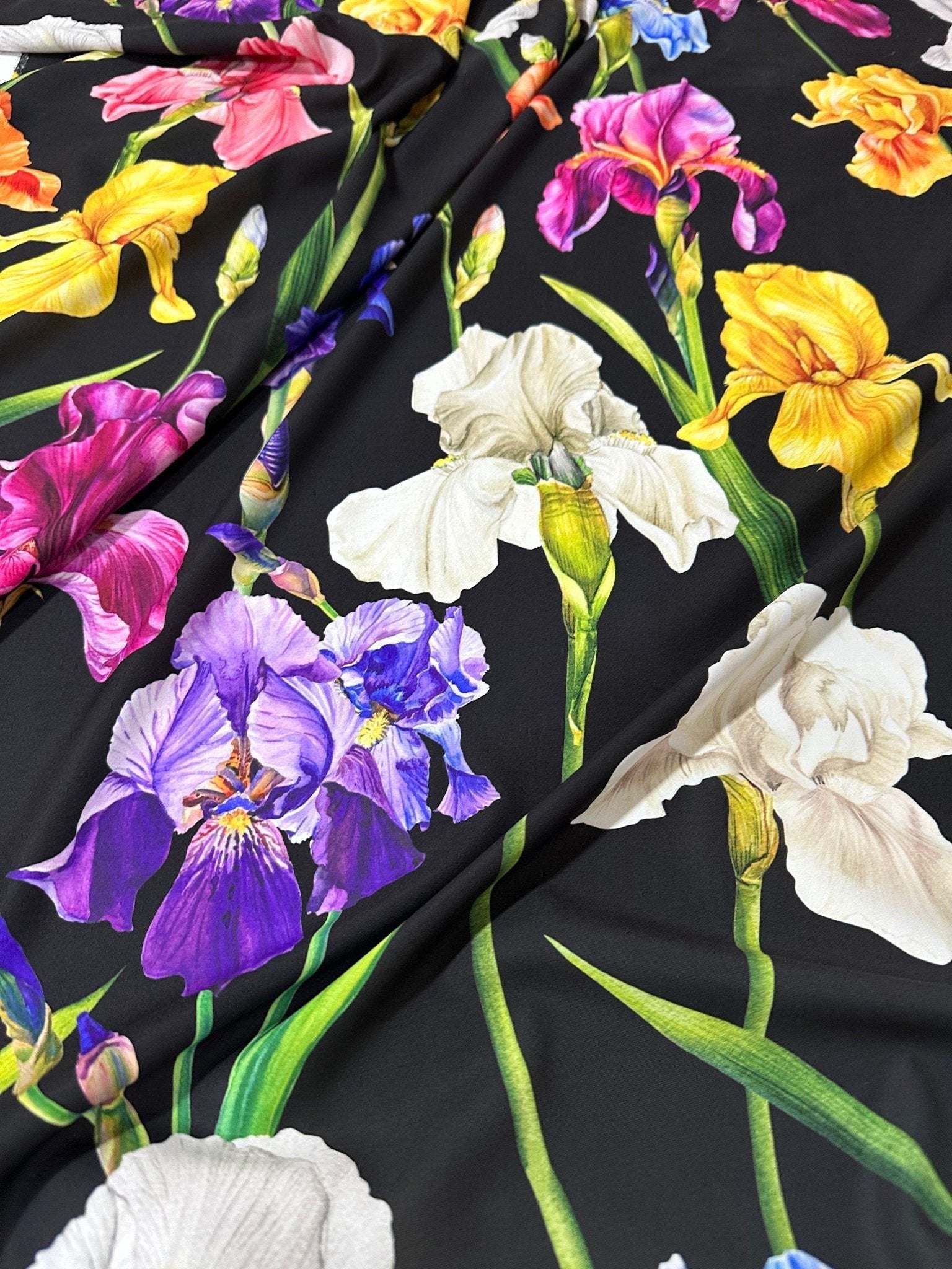 Floral Crepe Fabric with vibrant iris flowers on a black background, lightweight and soft texture for sewing projects