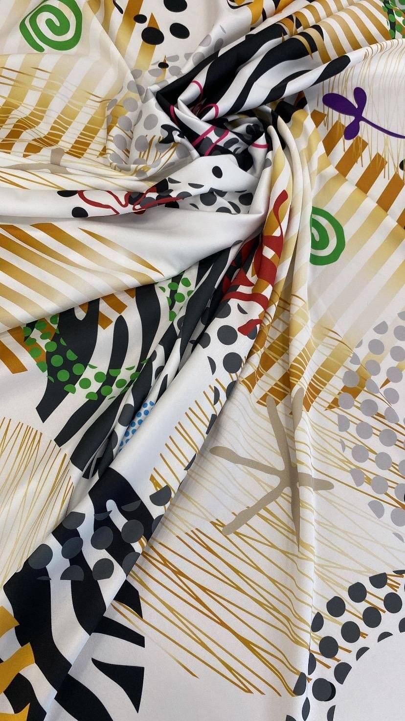 Modern polka dot, stripe, and swirl pattern fabric on white base with multicolor design