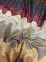 Multicolor pleated wave fabric with zigzag knit pattern in green and earthy tones, ideal for sewing garments
