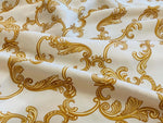 white fabric with gold baroque pattern close up texture