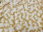 luxurious white fabric with intricate gold baroque pattern for dresswear