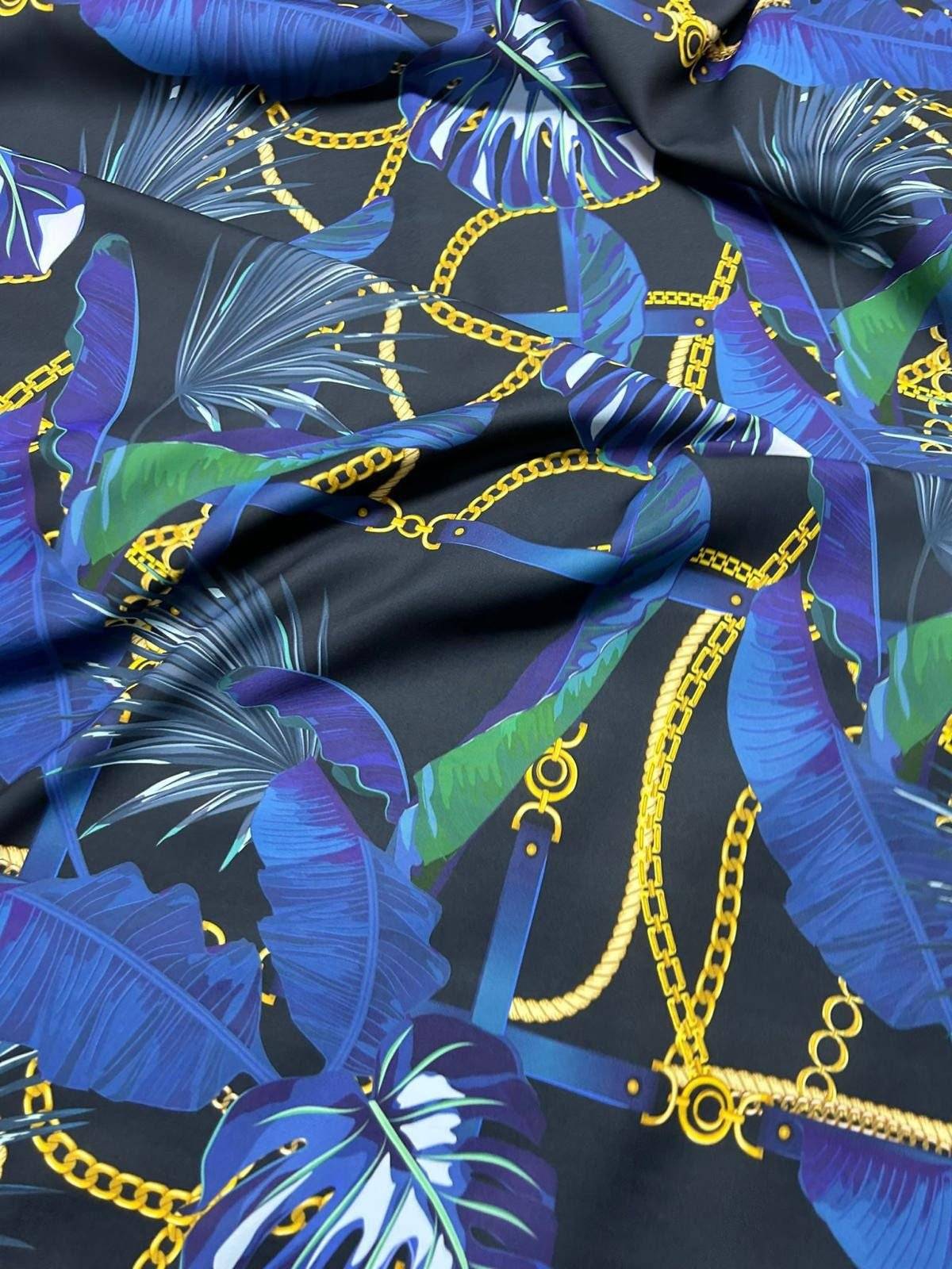 Navy blue fabric with leaf chain pattern featuring gold chains and tropical leaves