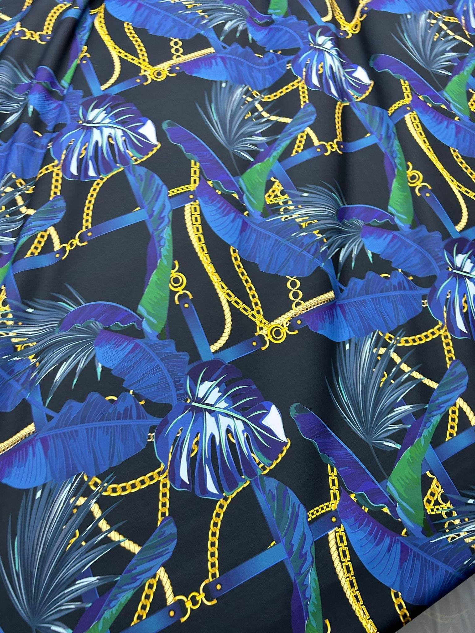 Navy blue fabric with leaf and gold chain pattern, suitable for apparel and home decor projects