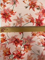 Orange and red lily floral fabric with soft texture and 150cm width for sewing and crafting projects