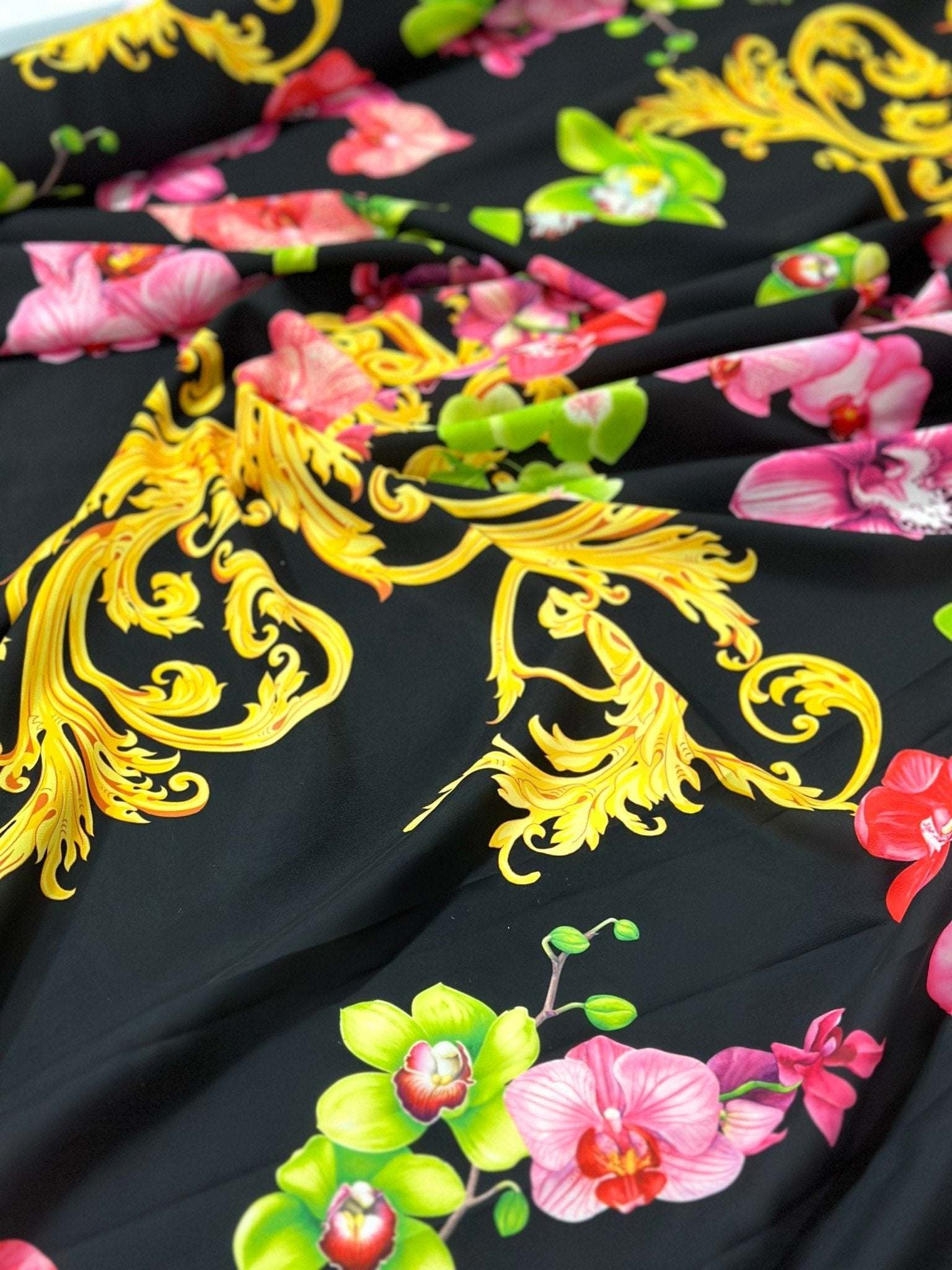Orchid Baroque floral fabric with vibrant pink and green orchids and intricate yellow baroque patterns on black background