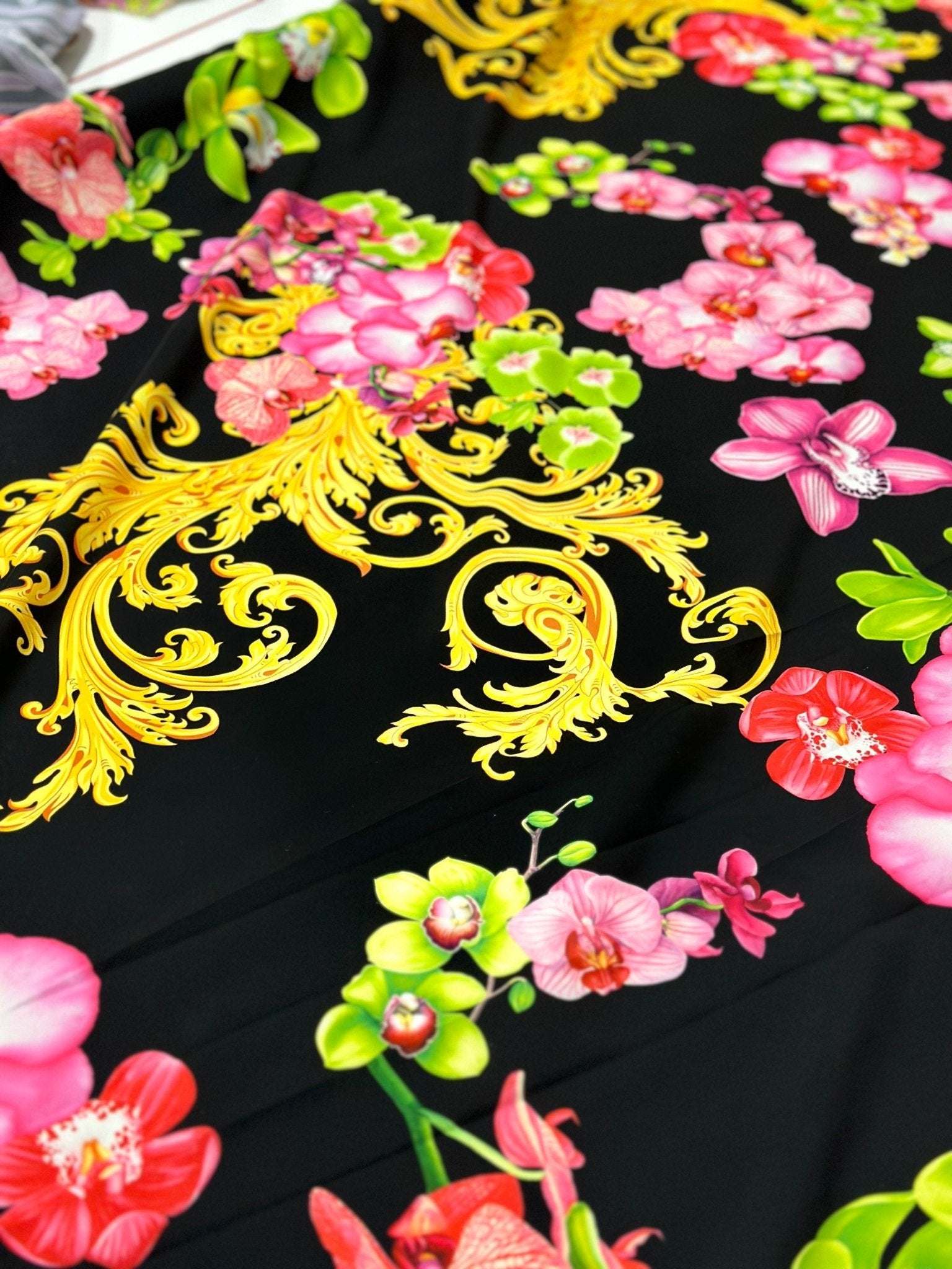 Orchid Baroque Floral Fabric with vibrant pink and green flowers and intricate gold baroque patterns on black background