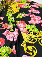 Orchid Baroque floral fabric with vibrant pink, red, and green flowers and intricate yellow baroque swirls on black background