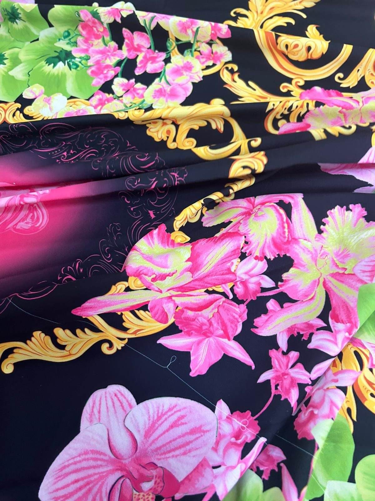 Orchid floral swirl print fabric with vibrant pink flowers and golden decorative swirls on black background