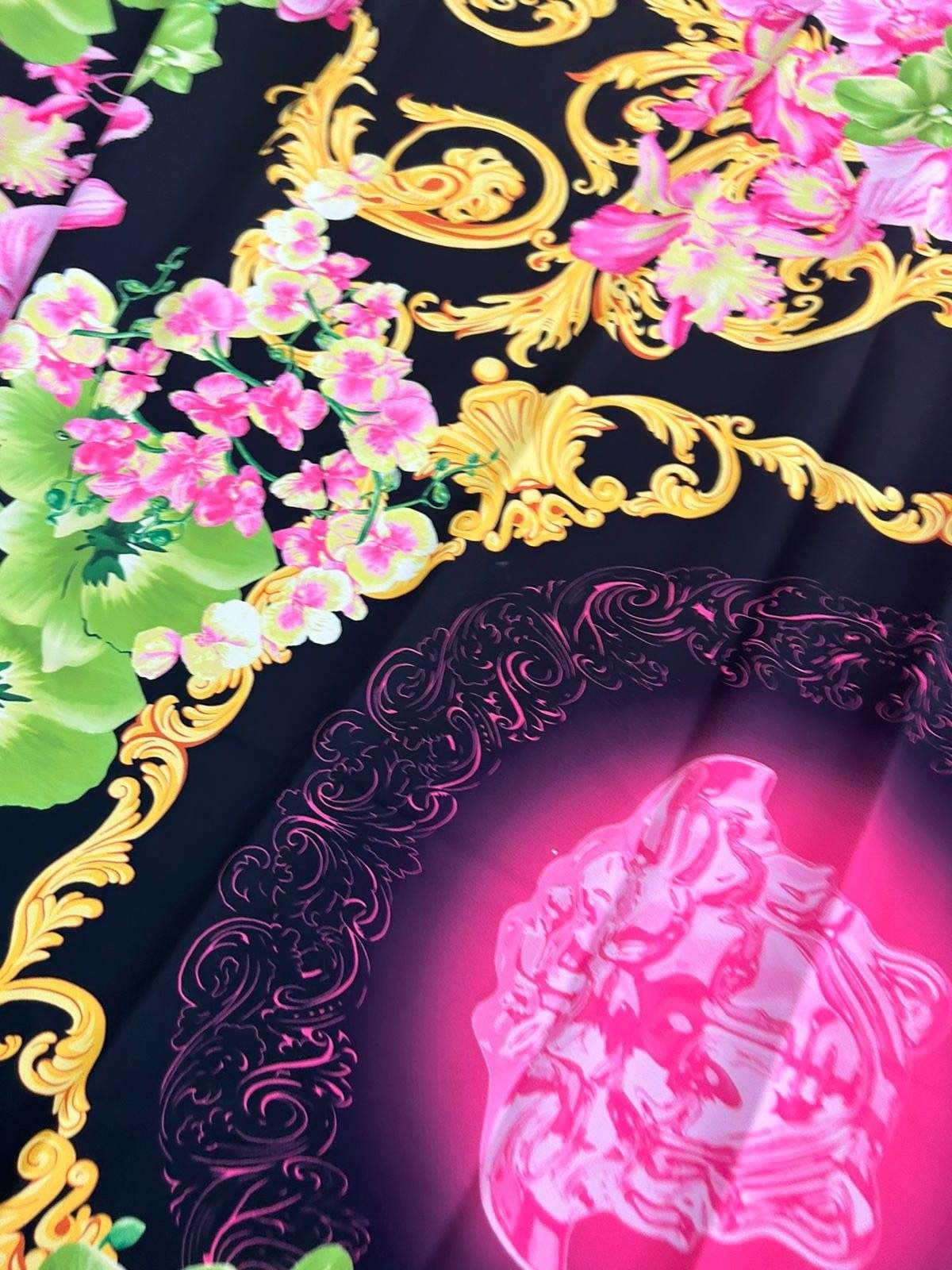 Orchid floral swirl print fabric with vibrant pink flowers and gold ornamental swirls on black background