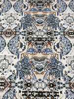 Ornamental ethnic print fabric in blue, brown, and beige with intricate patterns and 150cm width
