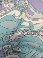 Pastel abstract swirl fabric with soft pastel colors and intricate swirling patterns close-up