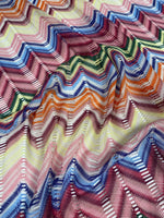 Pastel multicolor chevron mesh fabric with zigzag knit pattern in vibrant green, blue, pink, orange, and yellow tones.