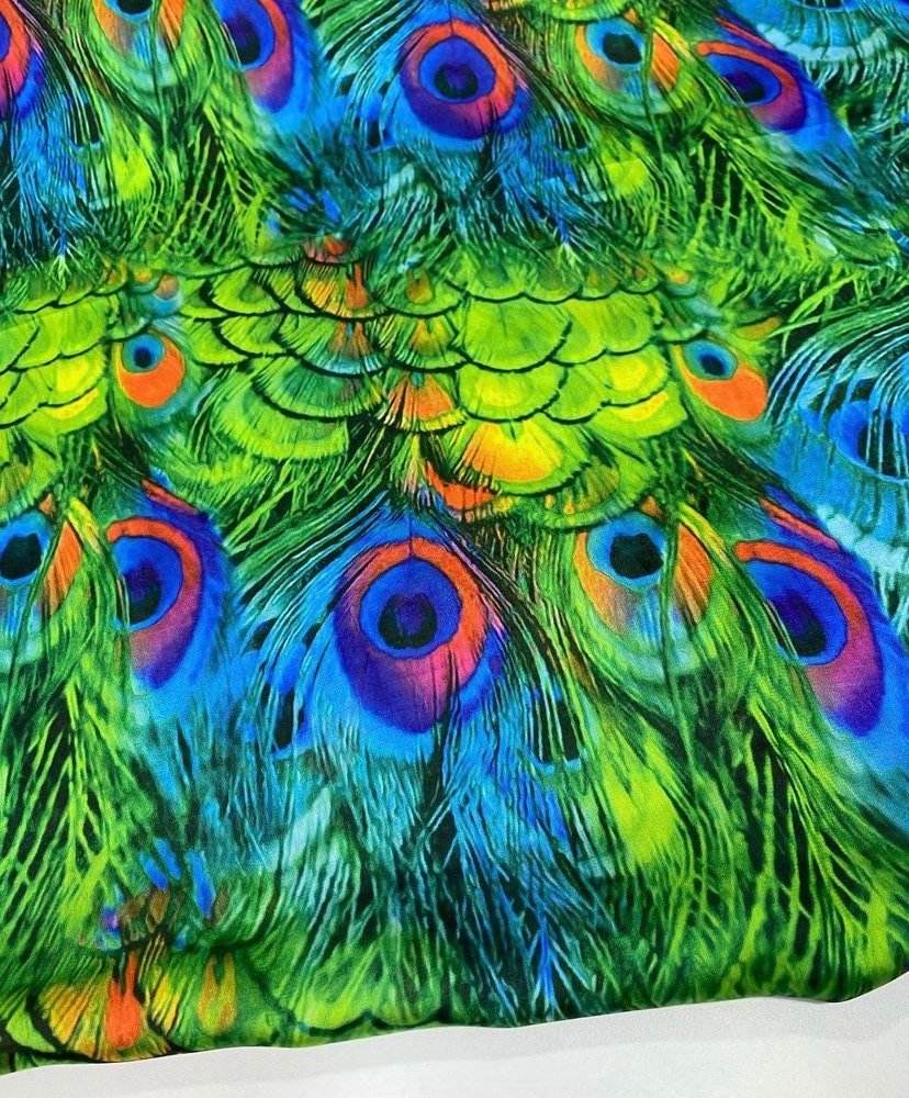 Vibrant green peacock feather fabric with detailed colorful eye patterns, sold by the yard for sewing and crafting projects