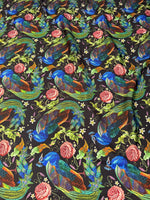 Vibrant peacock and rose patterned cotton fabric with floral and leaf motifs on dark background, ideal for sewing and quilting projects.