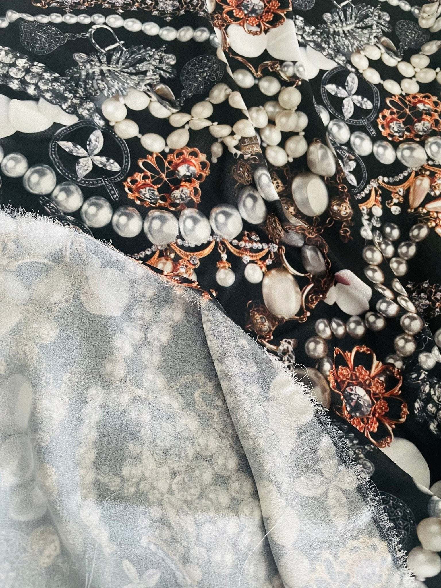 Black jewelry fabric with elegant pearl and gemstone pattern for stylish accessories