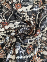 Black jewelry fabric with pearl and decorative patterns for elegant accessory crafting