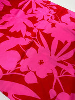 Tropical pink and red fabric with vibrant floral pattern for sewing projects