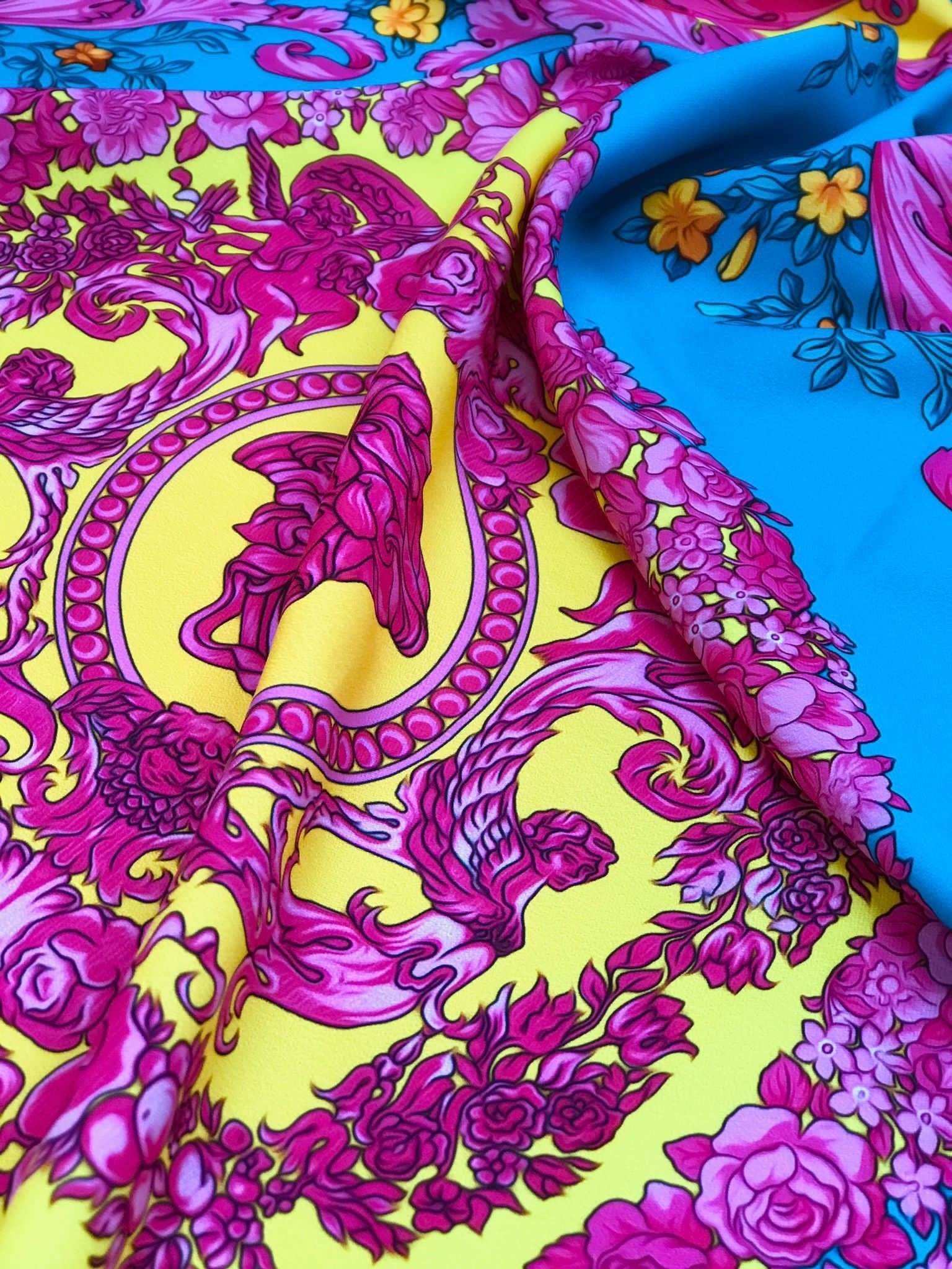 Pink Baroque silky fabric with vibrant floral and ornate patterns in pink, yellow, and blue colors