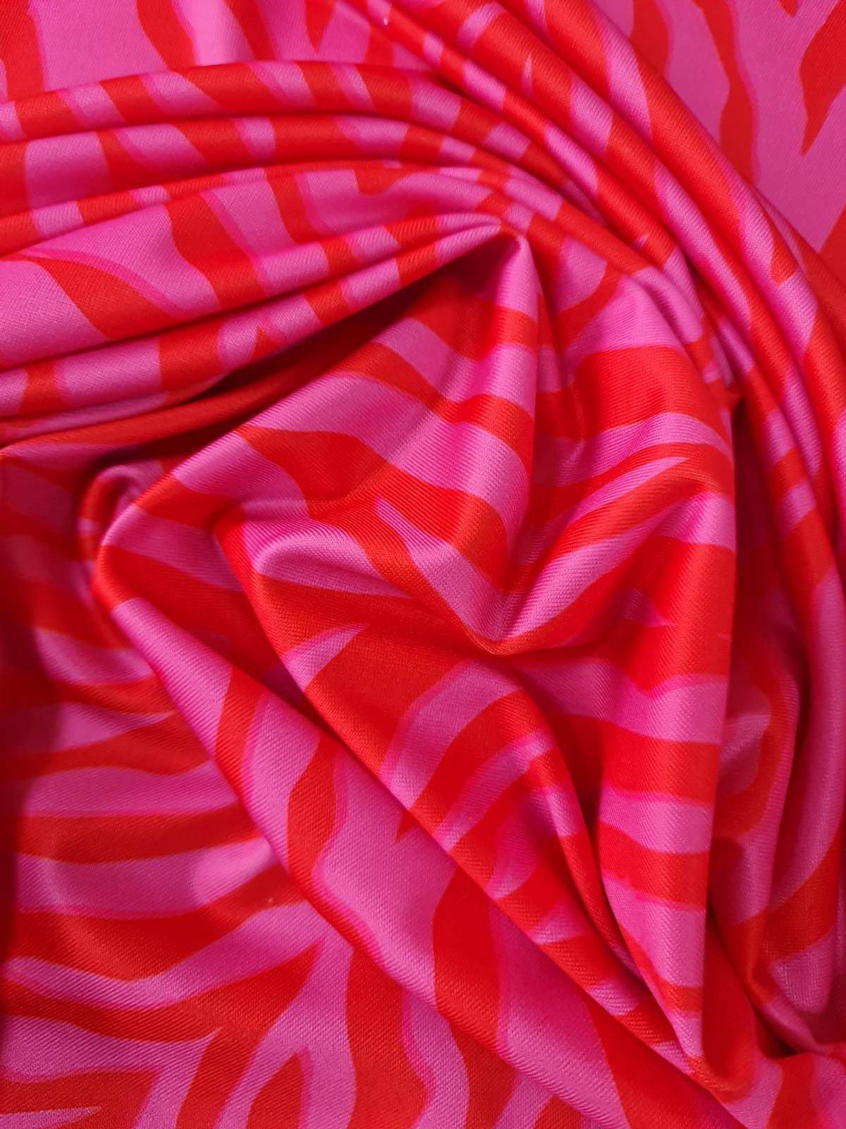 Red and pink tiger striped patterned fabric with vibrant bold design and 150cm width