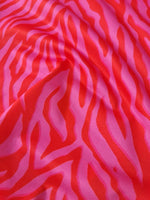 Red and pink tiger striped patterned fabric with vibrant bold design and 150cm width for clothing and crafts