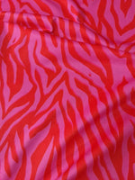 Red and pink patterned tiger striped fabric with vibrant bold design and 150cm width