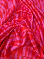 Red and pink tiger striped patterned fabric with vibrant bold design and 150cm width