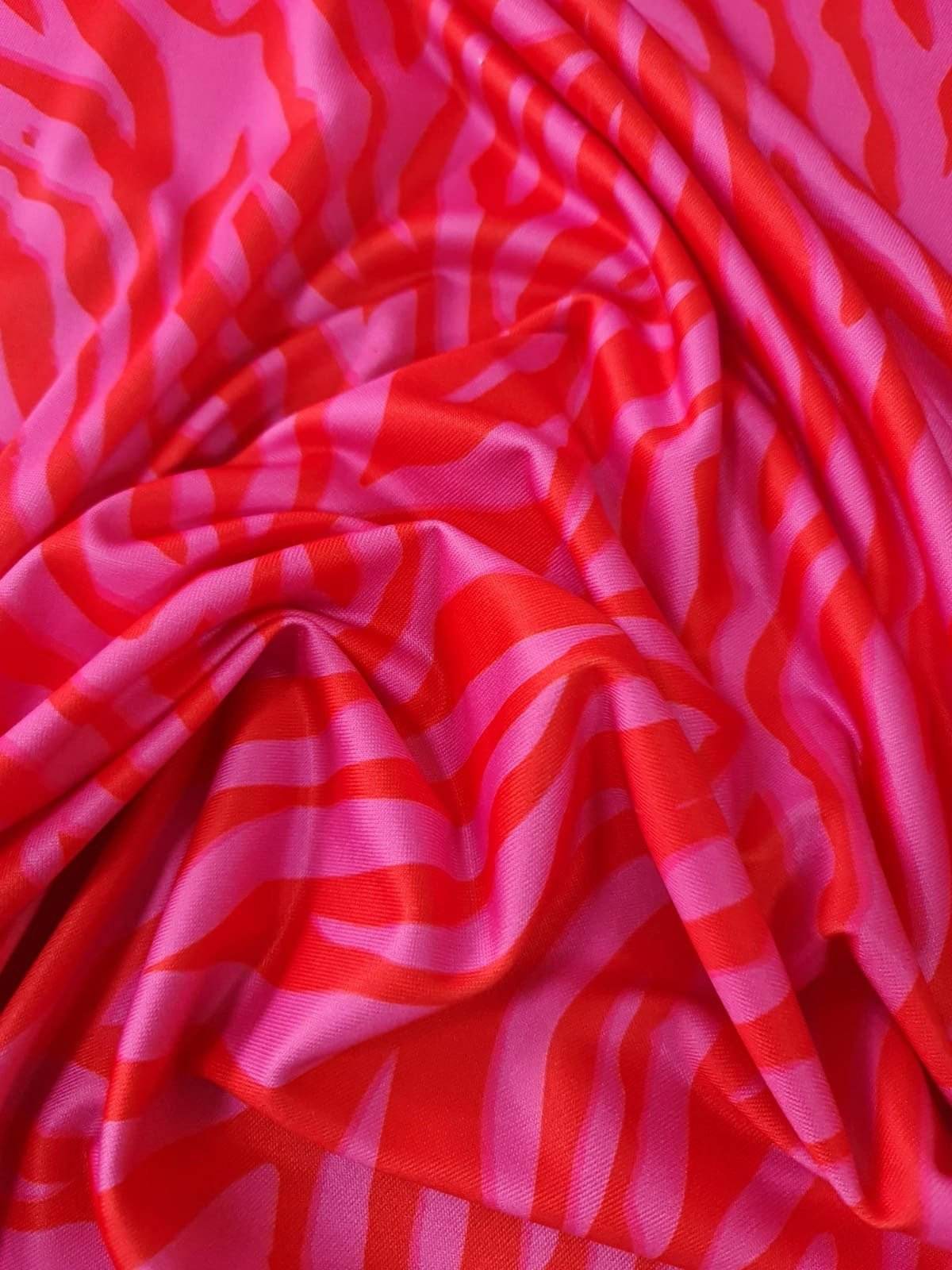 Red and pink tiger striped patterned fabric with vibrant bold design and 150cm width