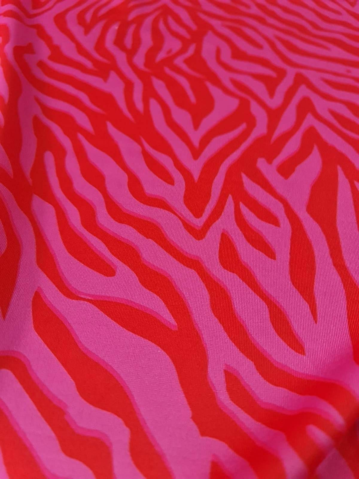 Close-up of red and pink tiger striped patterned fabric with a bold design
