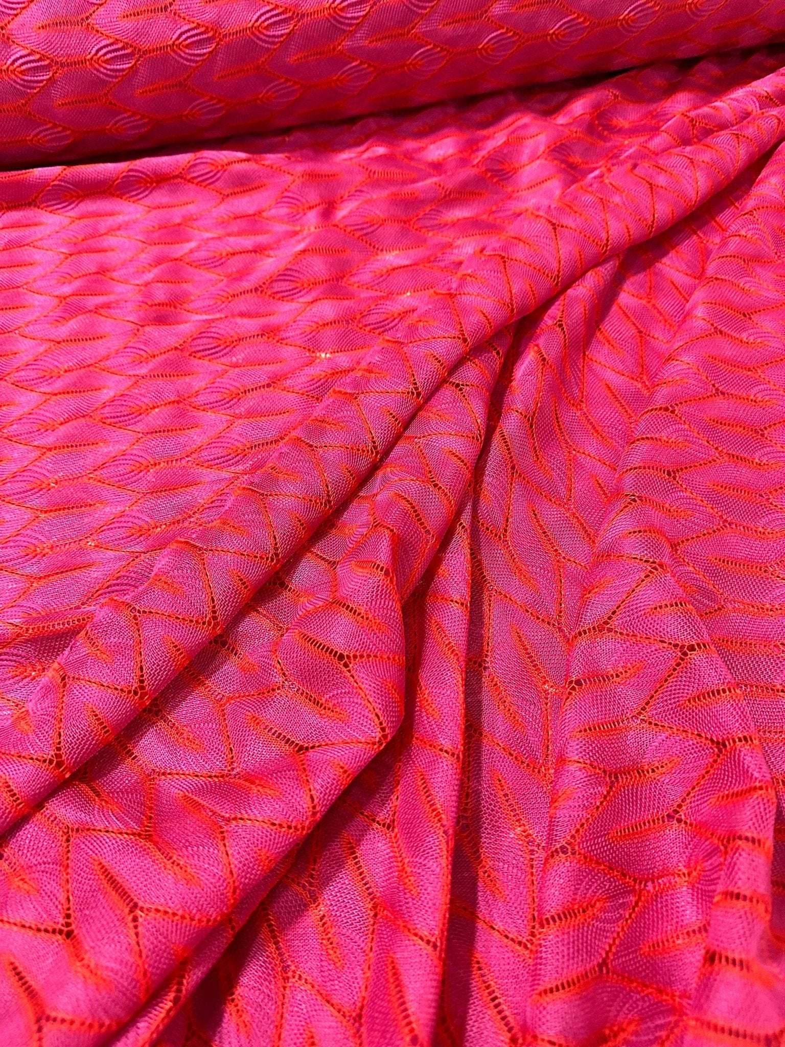 Pink and white chevron knit jersey fabric with zigzag pattern and soft texture
