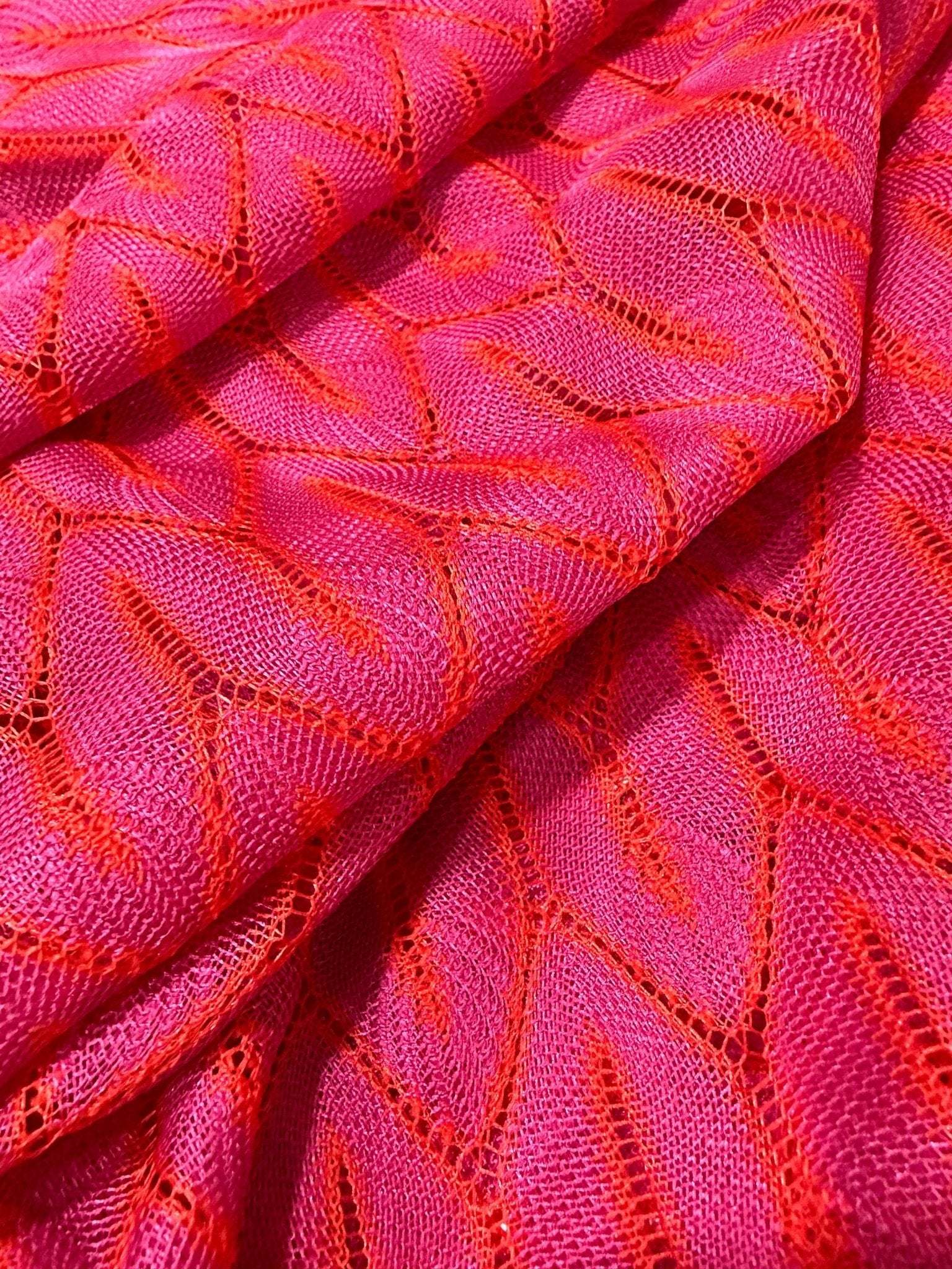 Pink and white chevron knit jersey fabric with a stylish zigzag pattern and soft texture
