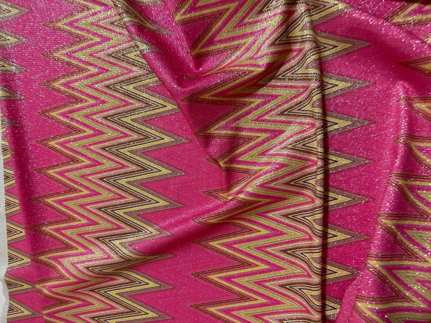 Pink zigzag knit fabric with gold lurex shimmer and 4-way stretch for activewear and costumes