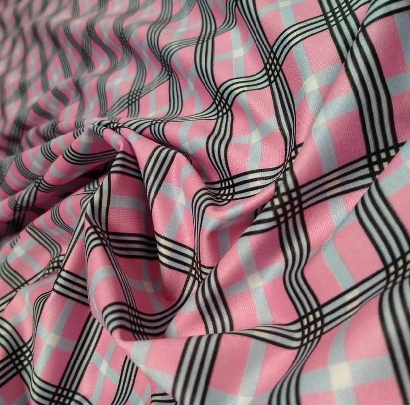 4-way stretch plaid fabric in pink, black, and light blue pattern with flexible texture