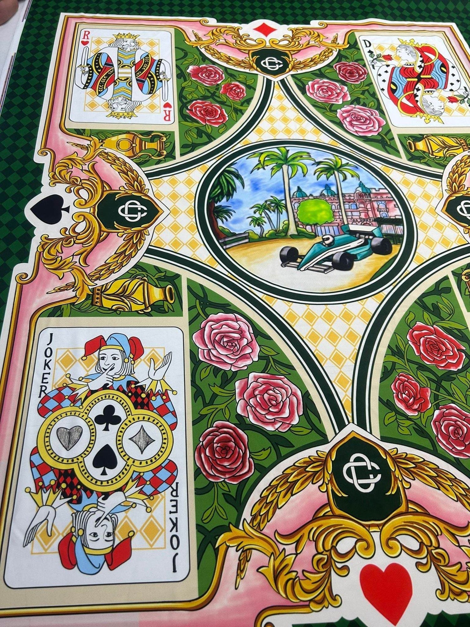 Playing Cards Silky crepe fabric with vibrant card designs, roses, and vintage car print on green and pink background