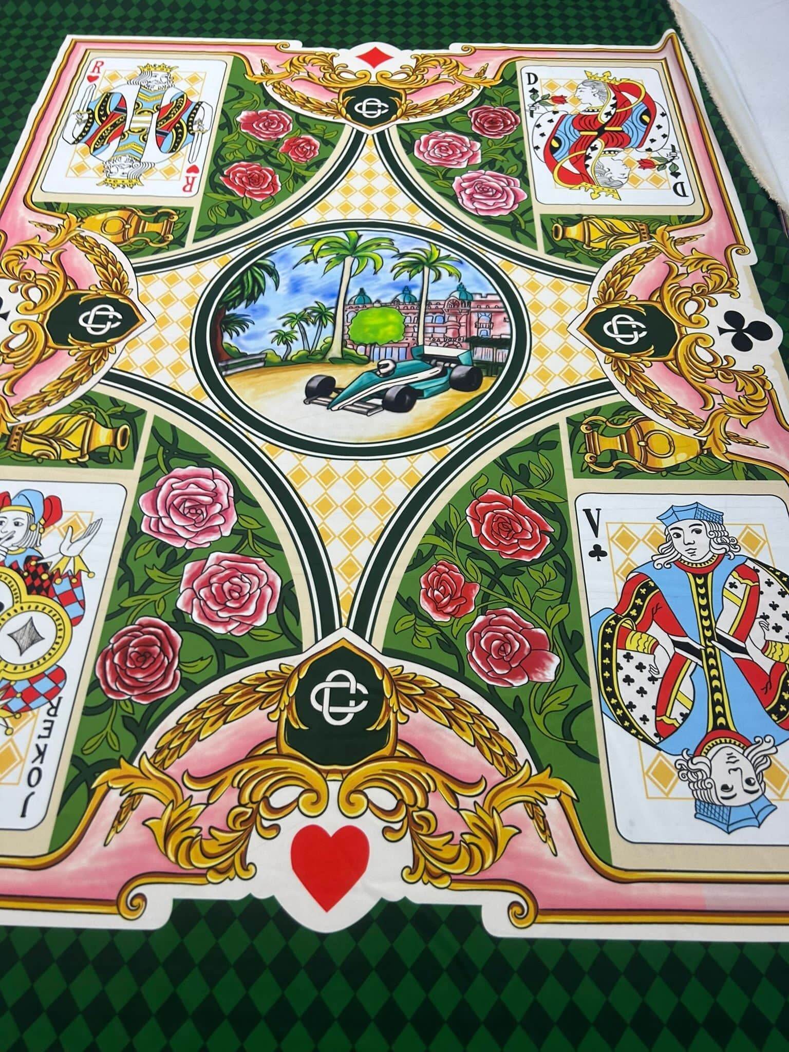 Silky crepe fabric with vibrant playing card design and floral accents for crafts and sewing projects