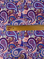 Purple paisley upholstery fabric with intricate digital print featuring blue, red, and green paisley and floral patterns.