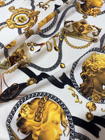 Queen and Rome Pattern Crepe Fabric with elegant gold and black classical motifs on white background