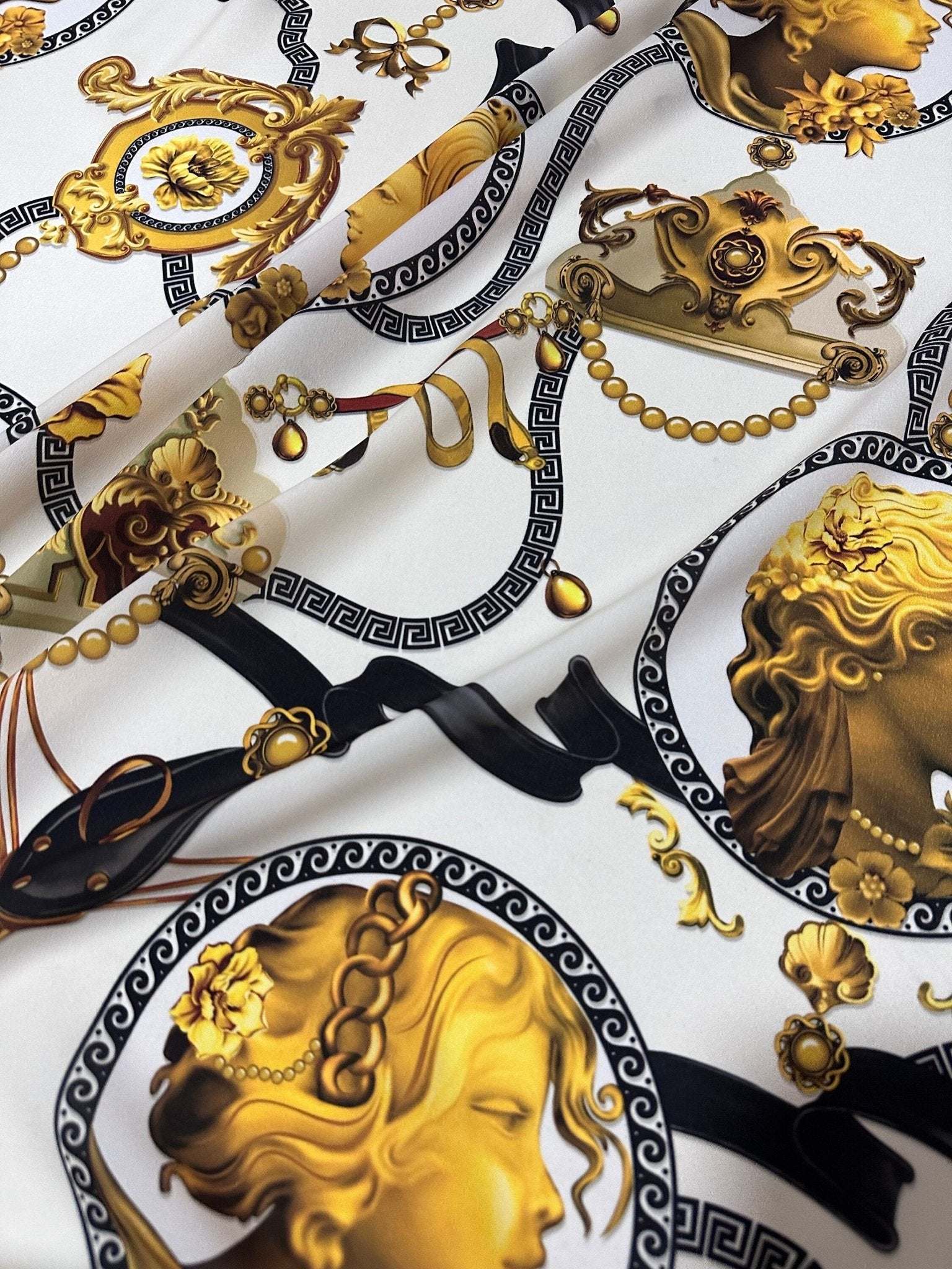 Queen and Rome Pattern Crepe Fabric with elegant gold and black classical motifs on white background