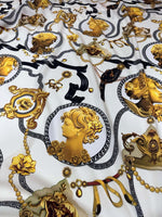 Queen and Rome pattern crepe fabric with intricate gold classical portraits and decorative motifs on white background