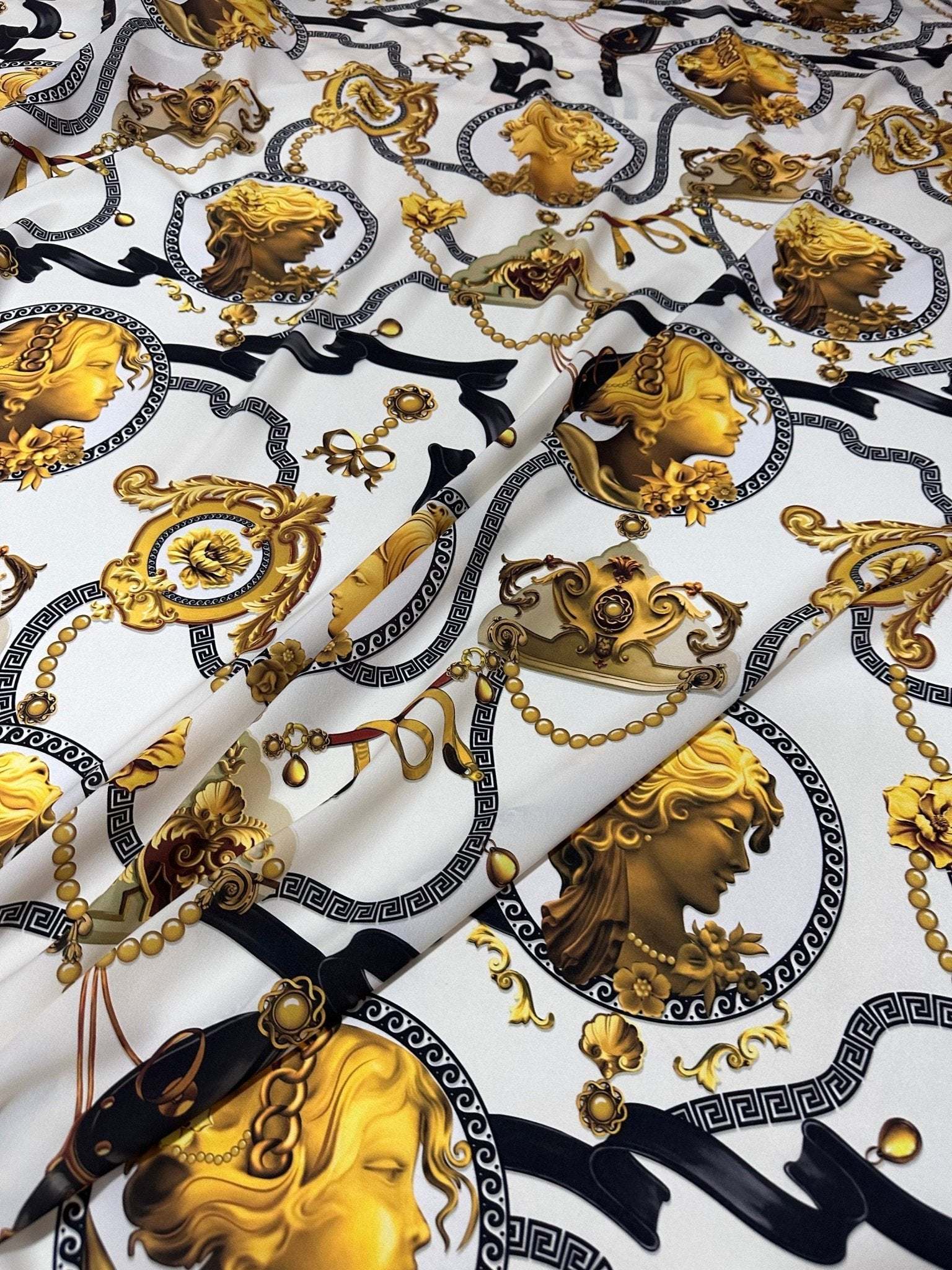 Queen and Rome Pattern crepe fabric with gold classical motifs on white background, 150cm wide textile for elegant sewing projects