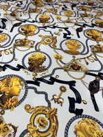 Queen and Rome Pattern crepe fabric with intricate gold and black classical portrait motifs on white background