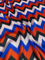 Red blue black zigzag chevron knit fabric with bold pattern and vibrant colors